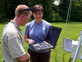 Boone County Stormwater Coordinator Georganne Bowman (right) works with Geosyntec Consultants technician Nick Muenks to set up a climate station in Sunrise Estates
