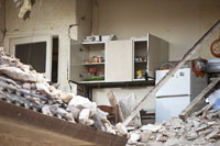 a kitchen surrounded by earthquake rubble